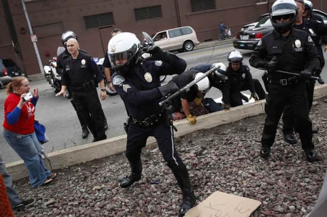 Officers wield batons during a rally in Los Angeles. Picture: Reuters