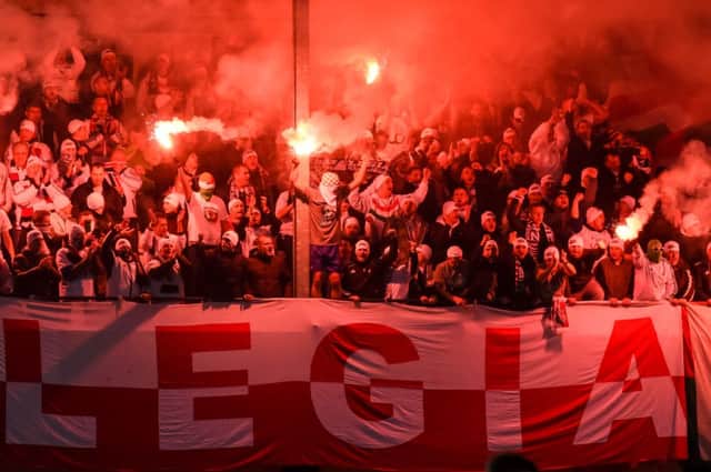 Legia Warsaw fans light flares during the Europa League match with Sporting Lokeren. Picture: AP