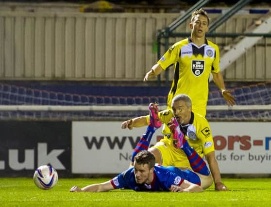 Jim Goodwin brings down Marley Watkins in the box to concede a penalty last night. Picture: Craig Foy/SNS