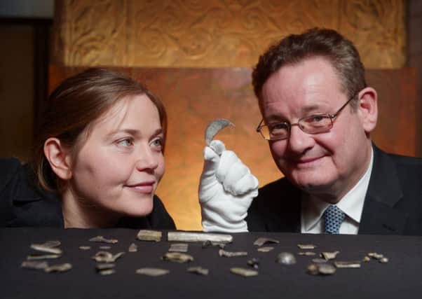 Alice Blackwell and Hamish Torrie holding a Late Roman Silver brooch along with other pieces. Picture: Phil Wilkinson