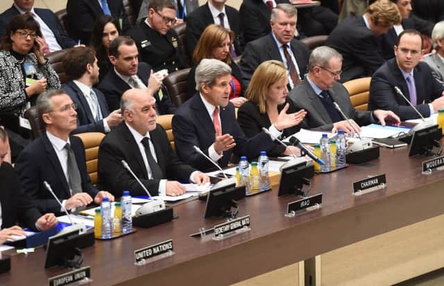 John Kerry addresses the 60-member coalition trying to crush Islamic State at the Nato HQ in Brussels yesterday. Picture: Getty