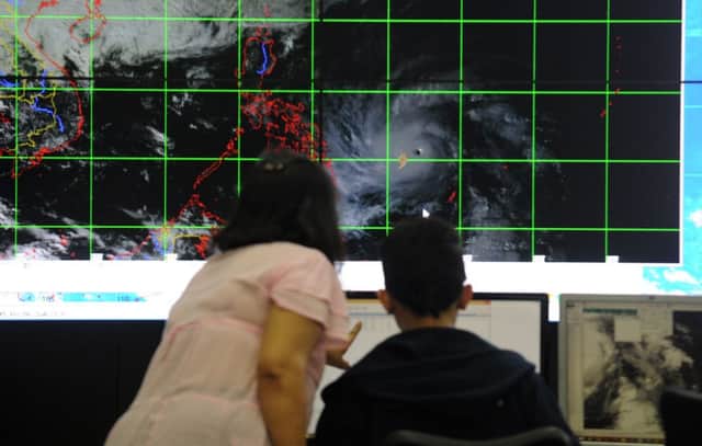 Meteorologists in the Philippines monitor the approach of Typhoon Hagupit. Picture: Getty Images