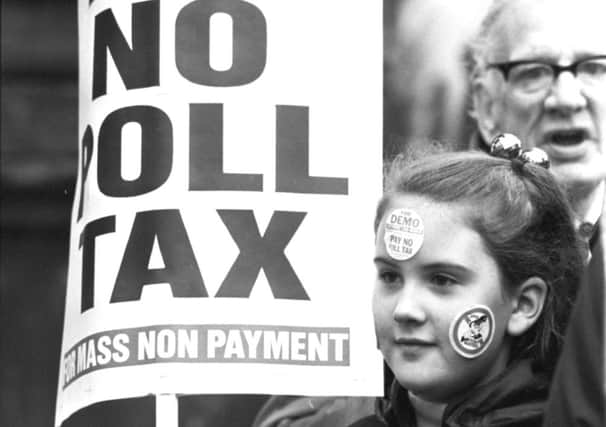 A girl demonstrates with a placard during an anti-poll tax march in Glasgow. Picture: TSPL