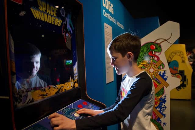Harry Williams plays Space Invaders
 at the Game Masters show. Picture: Alex Hewitt