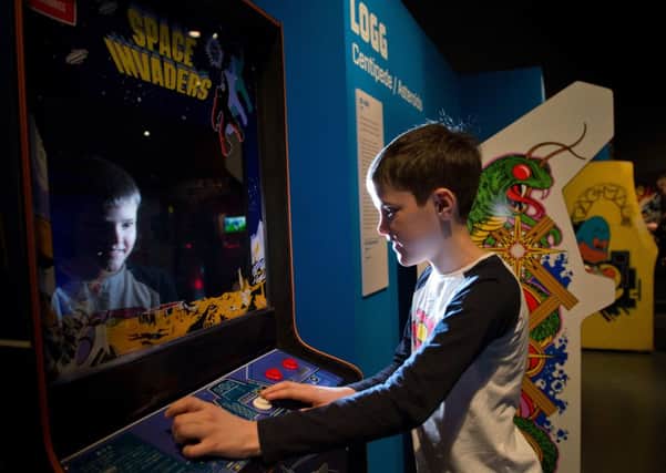 Harry Williams plays Space Invaders
 at the Game Masters show. Picture: Alex Hewitt