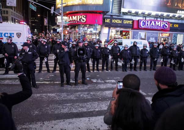 Police block demonstrators on Times Square following a decision by a  grand jury not to indict a police officer over Eric Garner's death. Picture: Getty