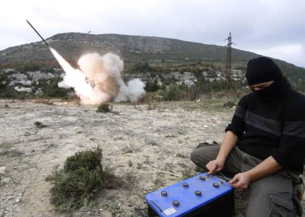 A rebel fighter fires a shell towards forces loyal to Assad in the city of Jableh.       Picture: Reuters