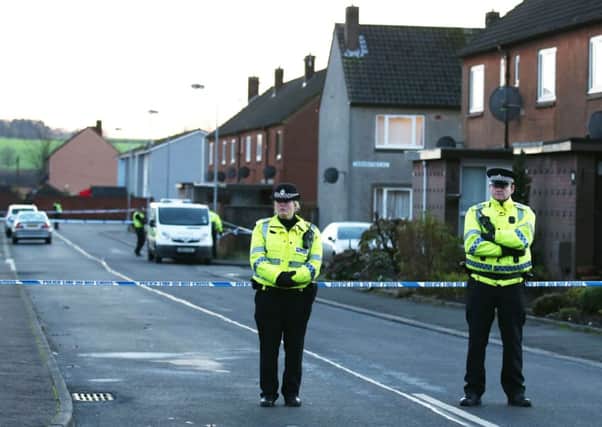 Police stand at the scene in Carnaughton Place in Alva. Picture: PA