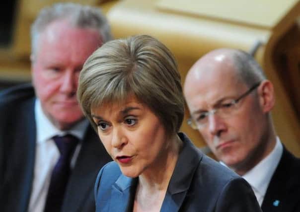 Nicola Sturgeon in action in the Holyrood chamber, watched by her colleagues on the SNP front-bench. Picture: Ian Rutherford
