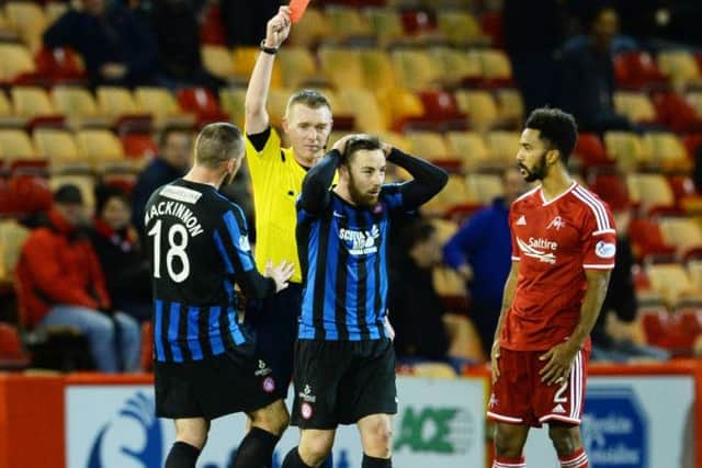 Hamilton's Jon Routledge (centre) is shown a red card by referee Craig Charleston. Picture: SNS
