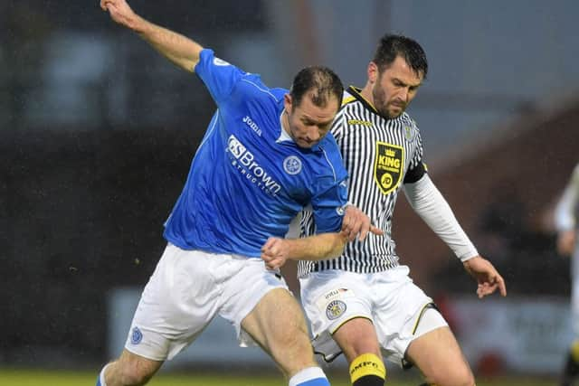 St Johnstone's Frazer Wright (left) and Steven Thomson battle for possession. Picture: SNS