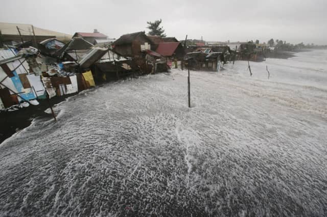 The sea encroaches on a coastal village in Albay province. Picture: AP