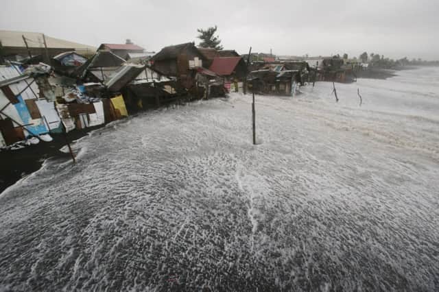The sea encroaches on a coastal village in Albay province. Picture: AP