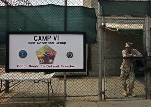 A soldier stands guard at the front gate entrance to Guantanamo's Camp 6 facility. Six more Guantanamo Bay detainees have been released. Picture: AP