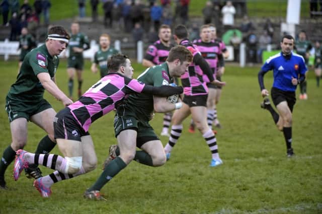 Hawick captain Rory Hutton holds off Kerr Gossman to score his teams first try. Picture: Rob Gray