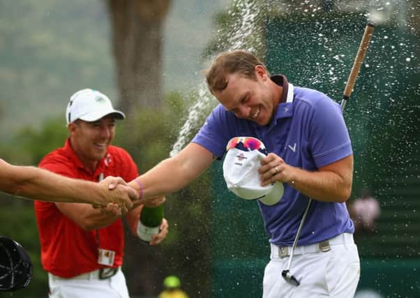 Danny Willett is sprayed with champagne as he celebrates victory in the Nedbank Golf Challenge. Picture: Getty