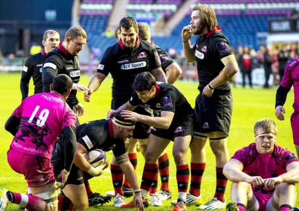Edinburgh's Rory Sutherland (4th from left) is congratulated by his team-mates after scoring his side's third try of the game. Picture: SNS