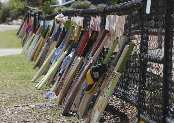 Cricket bats stand as tribute outside a primary school during the funeral of Phil Hughes in Macksville, Australia. Picture: AP