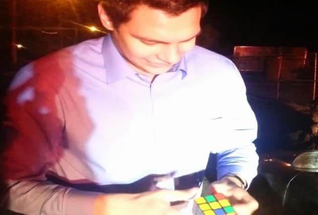 In this screengrab from Brundage's video, the magician solves the Rubik's cube. Picture: YouTube/Steven Brundage