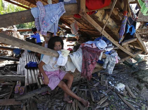 Young victims of the Typhoon; their home in Can-avid, Samar, in central Philippines, was destroyed by Hagupit. Picture: Reuters