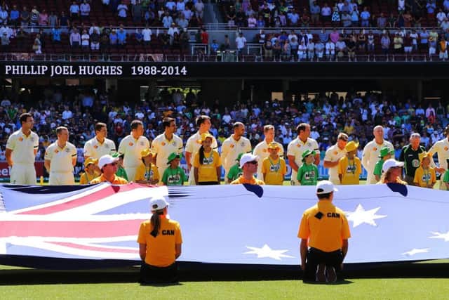 Australia players pay tribute to Phillip Hughes before the start of the first Test against India. Picture: Getty
