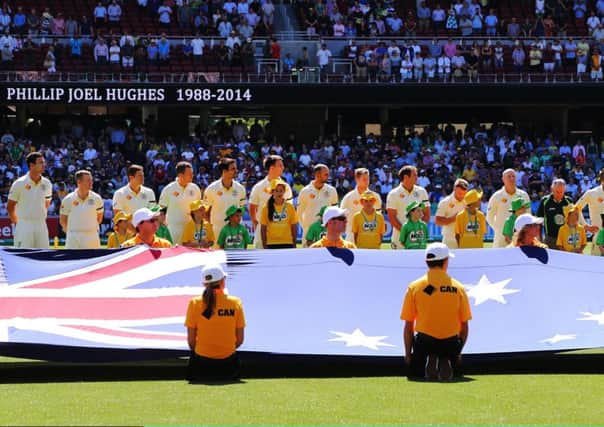 Australia players pay tribute to Phillip Hughes before the start of the first Test against India. Picture: Getty