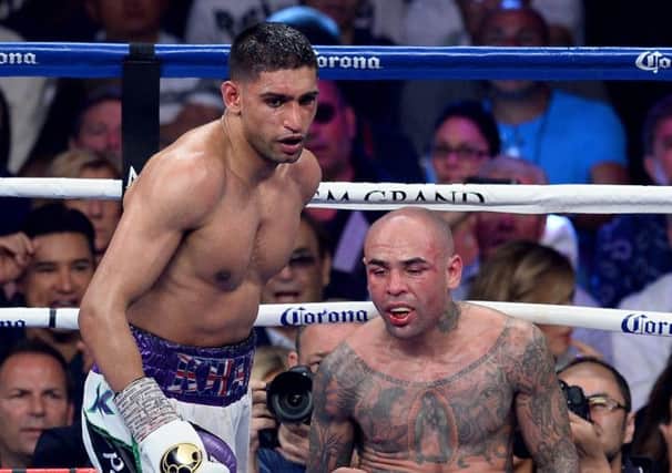 Amir Khan knocks down Luis Collazo during their bout in the MGM Grand Arena in May. Picture: Getty Images