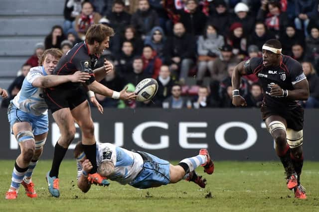 Toulouses French full-back Maxime Medard offloads as he is tackled by Jonny Gray last week. Picture: Getty