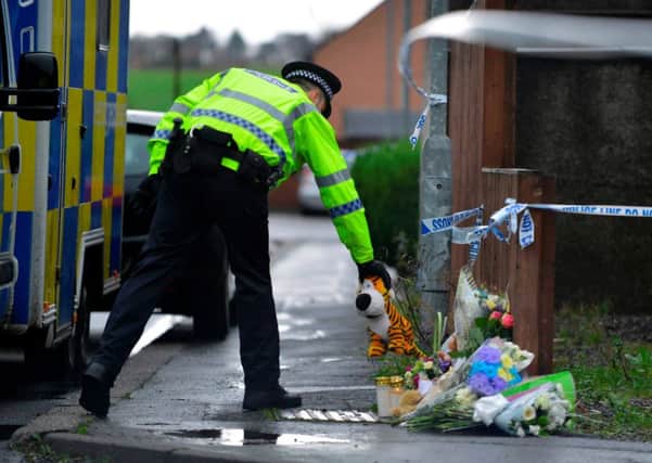 Police in Carnaughton Place, Alva, Clackmanshire, Scotland, beside tributes for a five-year-old boy who died in the area. Picture: Hemedia