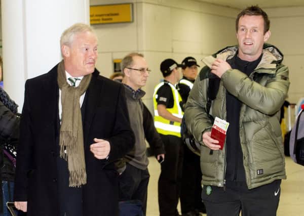 Celtic chairman Ian Bankier (left) and Ronny Deila make their way through Glasgow Airport yesterday. Picture: SNS