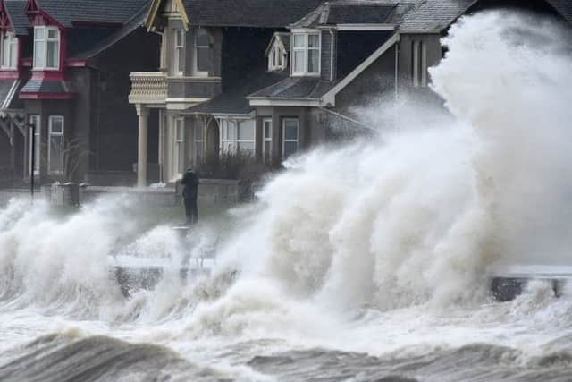 Waves crash against the promenade wall in Prestwick. Picture: Getty