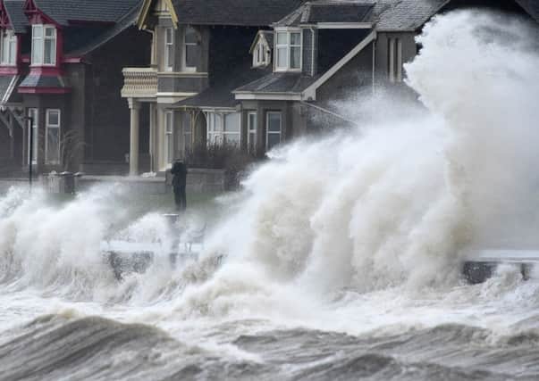 Waves crash against the promenade wall in Prestwick. Picture: Getty
