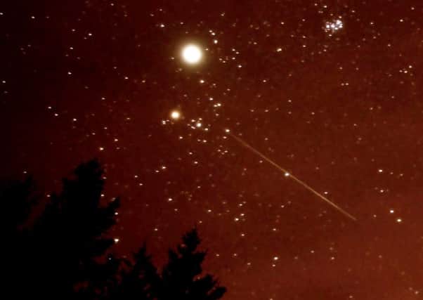 A stunning Germinid meteor swoops across the night sky above Scotland. Picture: Hemedia