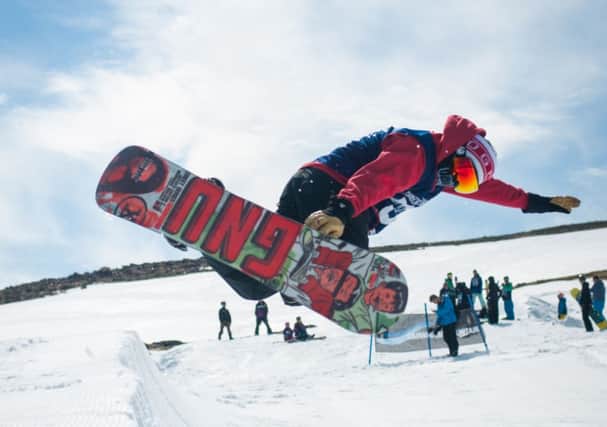 A snowboarder shows off a move at CairnGorm Mountain ski resort. Picture: Steven McKenna/Ski Scotland