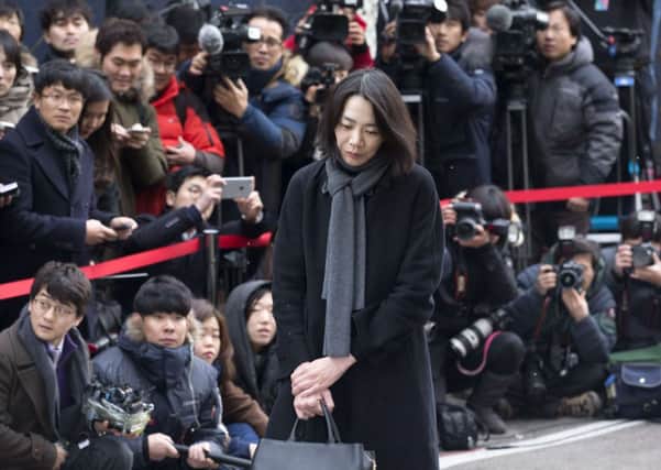 Heather Cho faces the media as she arrives at Seouls transportation ministry. Picture: Getty