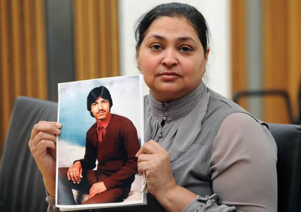 Manjit Sangha holds a picture of her brother Surjid Singh Chhokar in 2012. Picture: Ian Rutherford