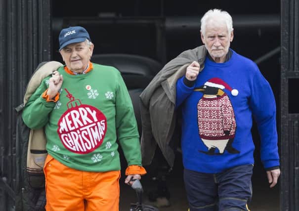 Christmas jumpers have gone from being a visual gag to becoming a national institution. Picture: PA