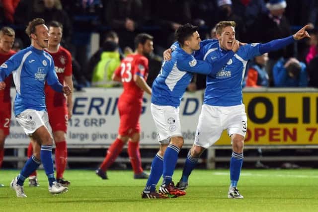 Queen of the South's Kevin Holt (right) celebrates after putting his side 1-0 up. Picture: SNS