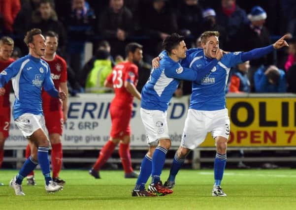 Queen of the South's Kevin Holt (right) celebrates after putting his side 1-0 up. Picture: SNS