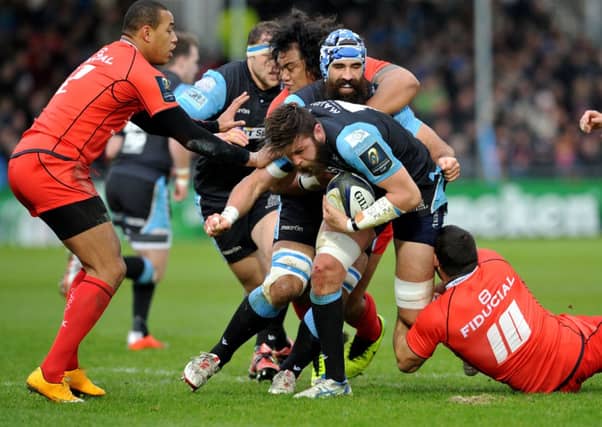 Glasgow's Ryan Wilson is tackled by Marc Doussain. Picture: Ian Rutherford