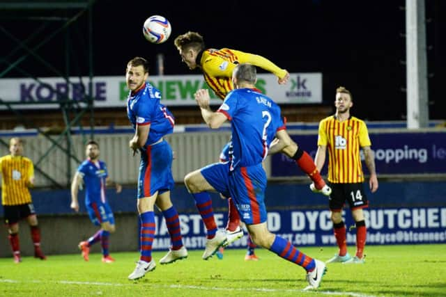 Partick Thistle's Gary Fraser (second from left) heads the ball into the net. Picture: SNS