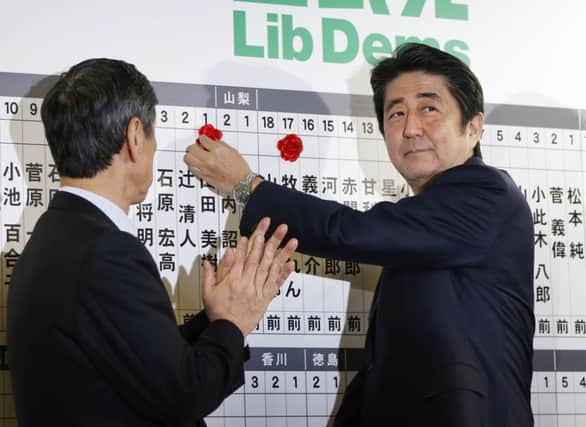 Shinzo Abe keeps track of votes at his Tokyo headquarters. Picture: Reuters