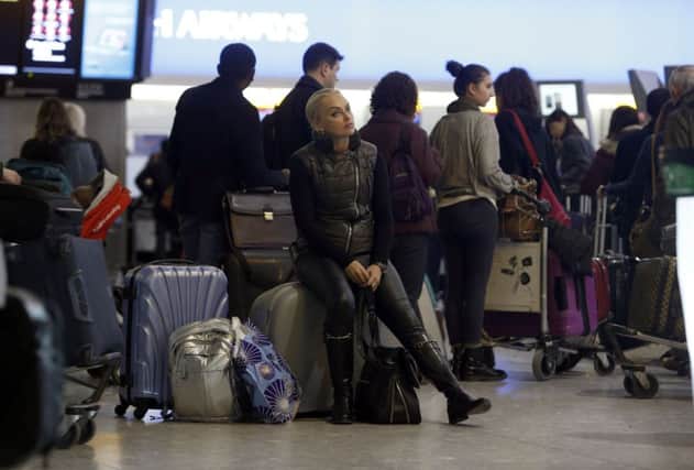 Passengers wait at Heathrow while a computer fault disrupts flights across the UK. Picture: PA