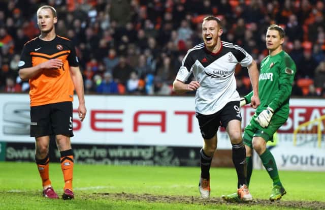 Adam Rooney celebrates after scoring the first of his two goals. Picture: SNS