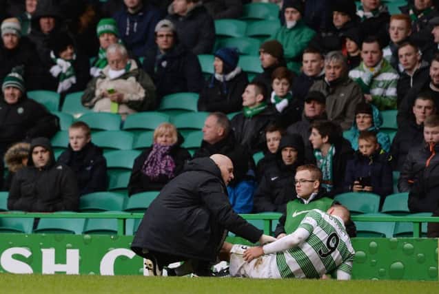 Celtic striker John Guidetti receives treatment before he was forced to limp off with an ankle injury to cap a frustrating afternoon. Picture: SNS