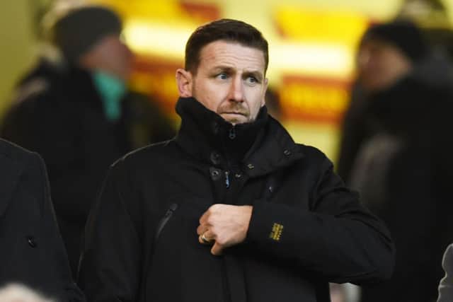 New Motherwell manager Ian Baraclough takes his place in the stand before the match. Picture: SNS