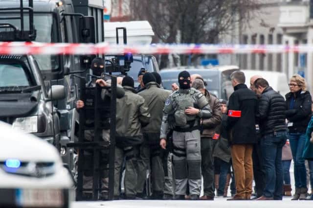 Special forces police prepare their equipment in Ghent outside the apartment. Picture: AP