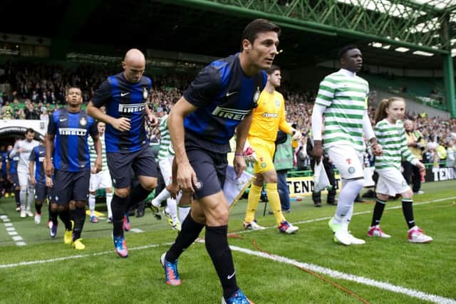 Victor Wanyama and JavierZanetti lead the teams out during Celtic's friendly with Inter Milan in 2012. Picture: SNS