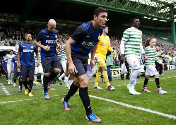 Victor Wanyama and JavierZanetti lead the teams out during Celtic's friendly with Inter Milan in 2012. Picture: SNS