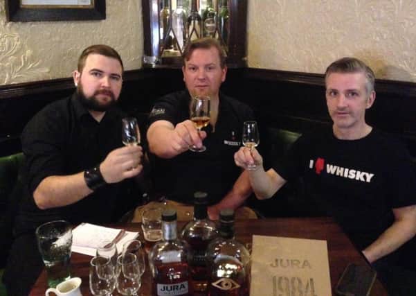 Sean Murphy, left, with Frank Murphy, middle, and Mark Connelly, right, enjoy the newest offering from Jura, the 1984. Picture: Sean Murphy